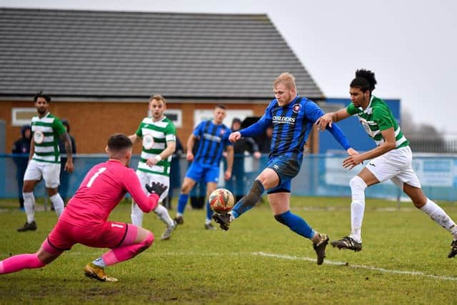 Jack Carter (blue) scored a crucial goal for Whittlesey Athletic at Sudbury.