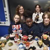 Jo Sludds, Headteacher at Manor Drive Academy  with head of English Mandy Pantling and children who entered at book week competition dressing potatoes.