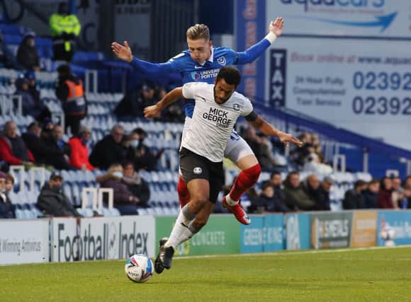 Posh defender Nathan Thompson, a former Portsmouth player, in action against Pompey's Ronan Curtis in Decmber, 2020. Photo: Joe Dent/theposh.com.
