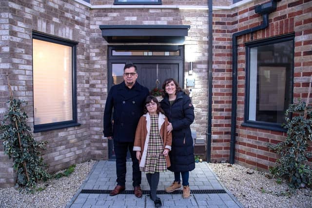 Carlos Ronceros, Monica Simarro and their daughter Sofia, outside their Bellway home at Springstead Village near Cambridge