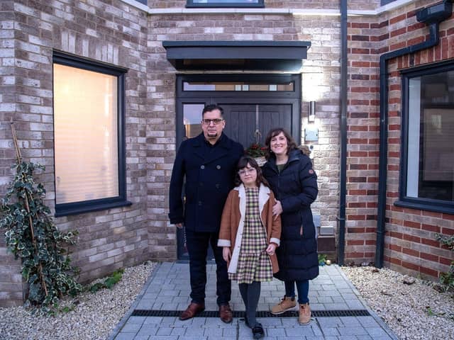 Carlos Ronceros, Monica Simarro and their daughter Sofia, outside their Bellway home at Springstead Village near Cambridge
