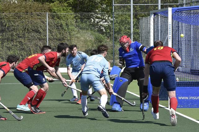 City of Peterborough goalkeeper Cam Goodey stands tall as Old Georgians (pale shirts) attack the D. Photo: David Lowndes.
