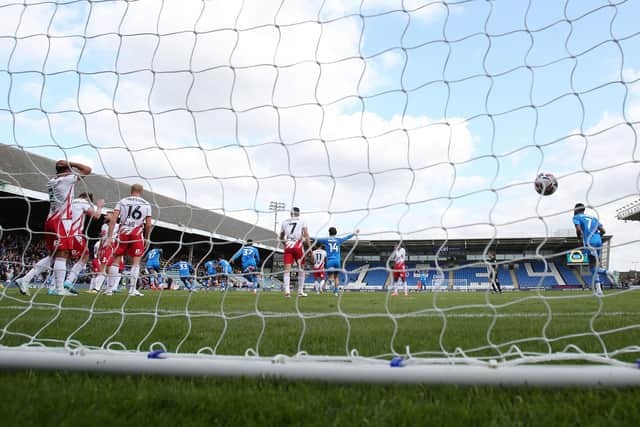 Peterborough United players rush to celebrate Kwame Poku's winning goal against Stevenage. Photo Joe Dent/theposh.com.