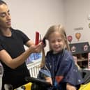 Tom Butler (3) of Peterborough has his hair cut by Erica for the Little Princess Trust