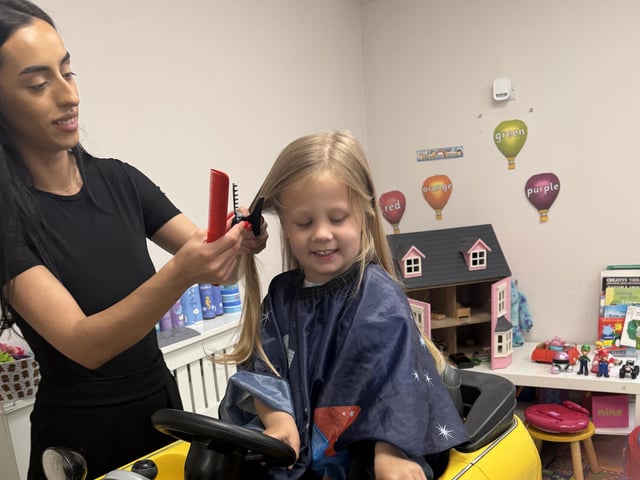 Tom Butler (3) of Peterborough has his hair cut by Erica for the Little Princess Trust