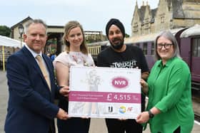 Mark Hernandez and Del Singh presenting a cheque to Sarah Piggott and Tracy Spring of Nene Valley Railway from money raised through the Octopussy Bond weekend