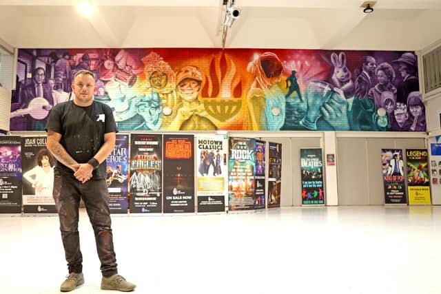 Nathan Murdoch puts the finishing touches to his Cresset mural on August 21 (image: Paul Marriott).