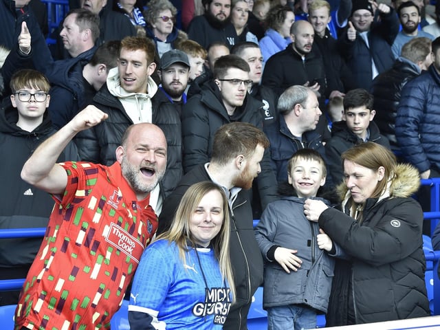Peterborough United fans are pictured watching the crucial win over Derby County.