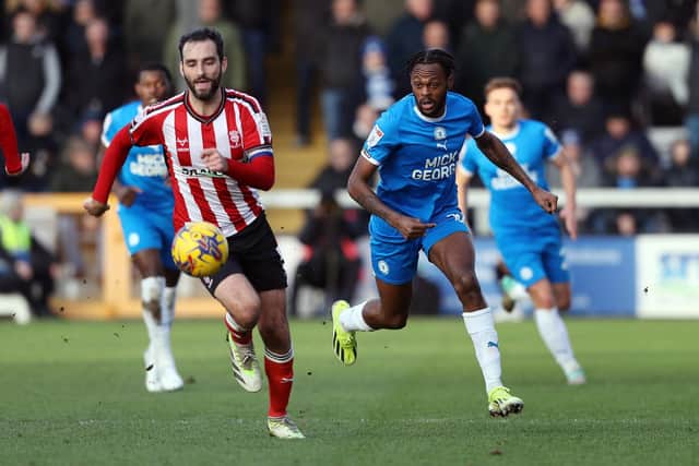 Ricky-Jade Jones of Peterborough United tracks the ball against Lincoln City. Photo: Joe Dent/theposh.com.