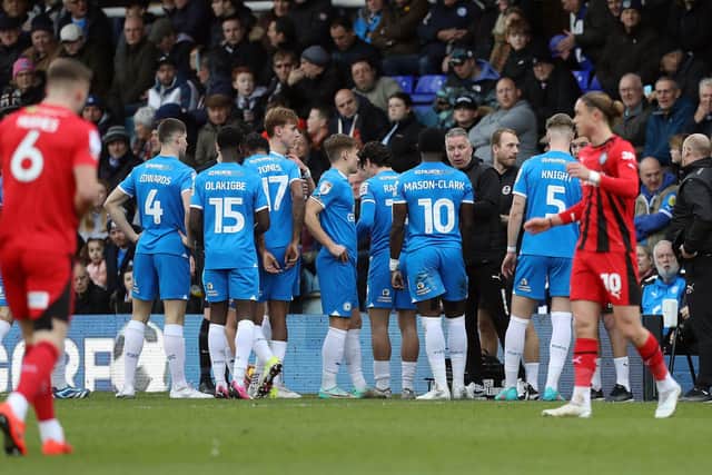 Peterborough United manager Darren Ferguson talks to his players during a break in play against Wigan. Photo: Darren Ferguson.