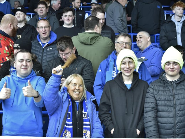 Peterborough United fans are pictured watching the crucial win over Derby County.