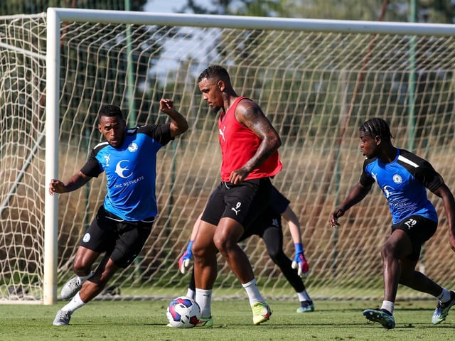 Jonson Clarke-Harris is put under pressure by Nathan Thompson and Benjamin Mensah during a training match. Photo: Joe Dent/theposh.com