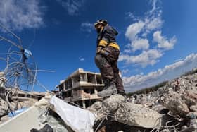 A rescue worker stands amid the rubble of a building days after an earthquake hit Turkey and Syria.. (Photo by Rami al SAYED / AFP) (Photo by RAMI AL SAYED/AFP via Getty Images)