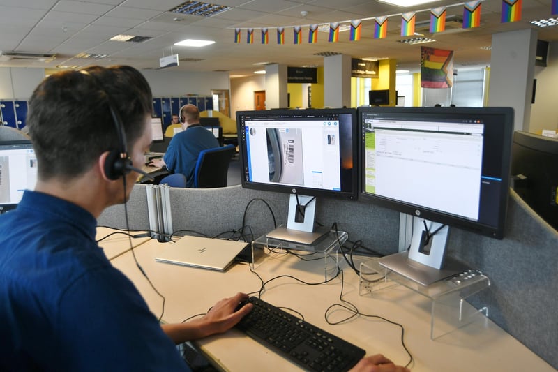 The call centre at Whirlpool where a colleague helps a customer via her mobile phone correct a fault with a washing machine.