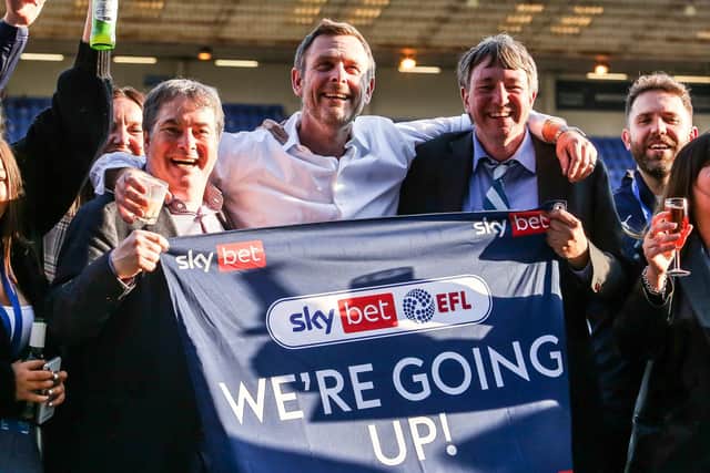 Co-owners, from left, Stewart Thompson, Darragh MacAnthony and Jason Neale celebrate the Posh promotion of 2020-21. Photo: Joe Dent/theposh.com