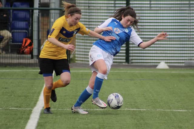 Jess Driscoll (blue) in action for Posh Women.