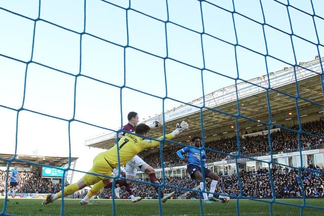 Nathanael Ogbeta of pokes in Posh's second against Derby. Photo: Joe Dent.