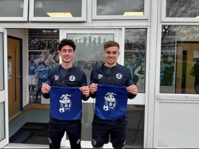 Peterborough United players Joel Randall and Archie Collins with the new sensory packs. Photo: Peterborough United.