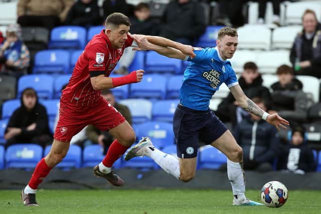 Jack Taylor of Peterborough United in action with Sean Long of Cheltenham Town. Photo: Joe Dent/theposh.com.