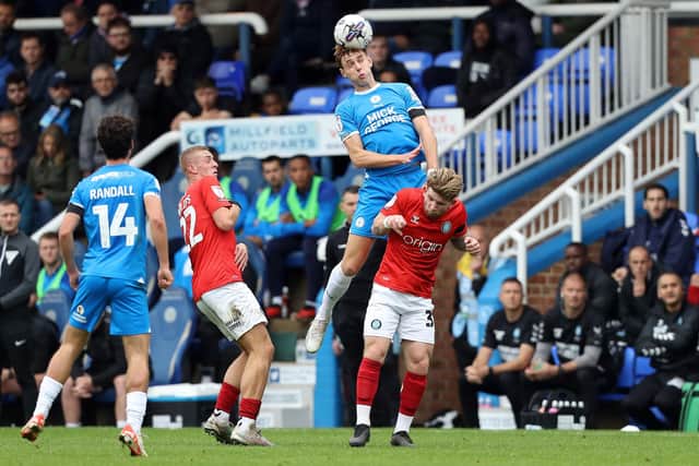 Hector Kyprianou of Peterborough United outjumps Jasper Pattenden of Wycombe Wanderers. Photo: Joe Dent/theposh.com.