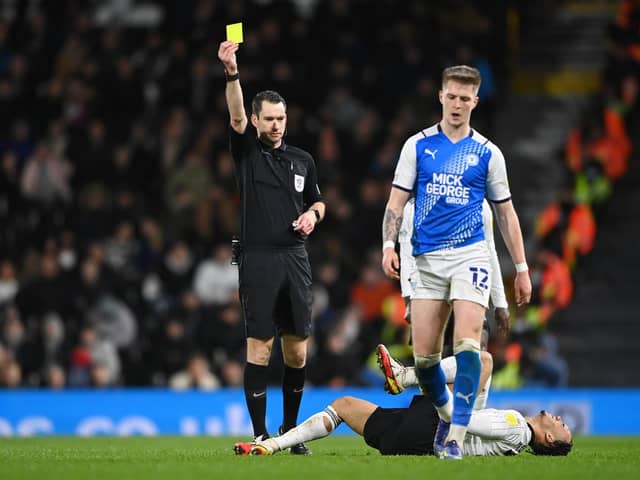 Peterborough's Josh Knight is booked against Fulham. It is one of 80 yellows for Posh this season.