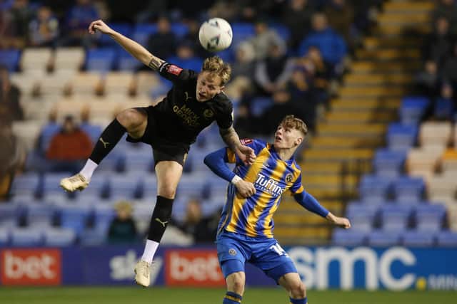 Frankie Kent of Peterborough United gets to the ball before Rob Street of Shrewsbury Town. Photo: Joe Dent/theposh.com.