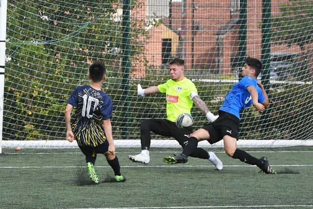 A goal for Farcet (blue) against Hampton FC in their Challenge Cup tie. Photo: David Lowndes.