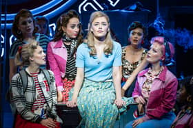 India Chadwick and the cast of Grease on stage