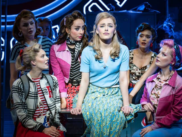India Chadwick and the cast of Grease on stage