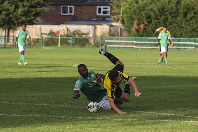 Romeo Ugbene (green) of FC Peterborough was sent off for this foul against Crowland. Photo: Tim Symonds.