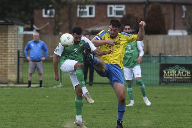Michael Goncalves (green) in action for FC Peterborough Reserves against Sawtry.