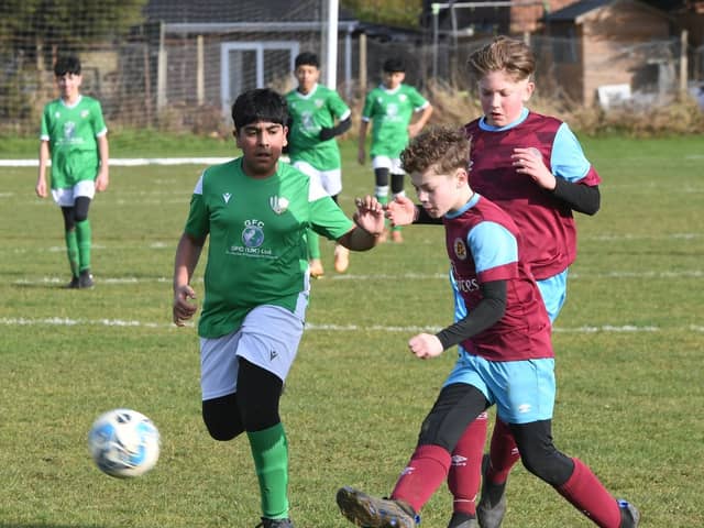 Action from a recent under 13 game between Deeping Rangers and FC Peterborough (green). Photo: David Lowndes.