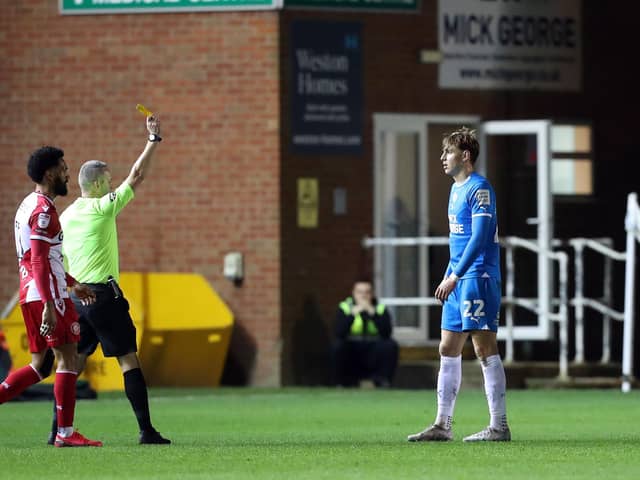 Hector Kyprianou of Peterborough United is shown a yellow card. Photo: Joe Dent.