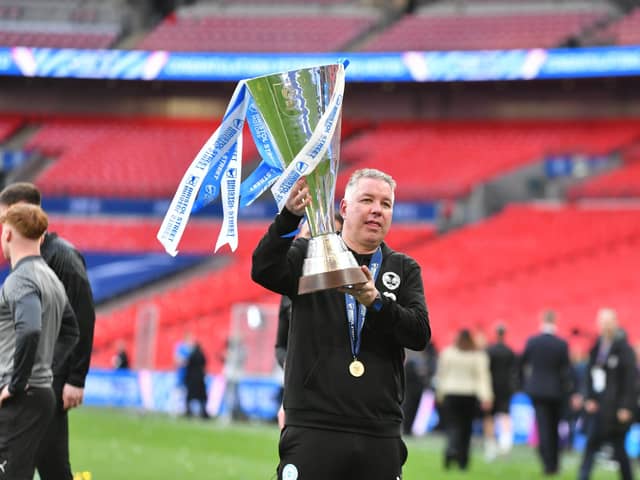 Peterborough United boss Darren Ferguson lifts the Bristol Street Motors Trophy at Wembley.