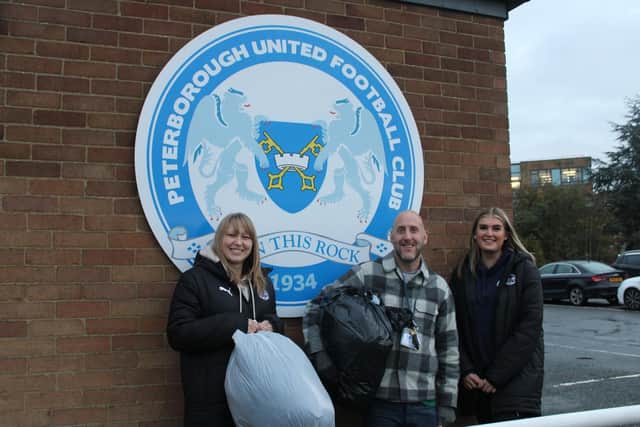 Jenna Lusk and Emily Purbrick from the Posh Foundation hand over the coats to the Light Project.