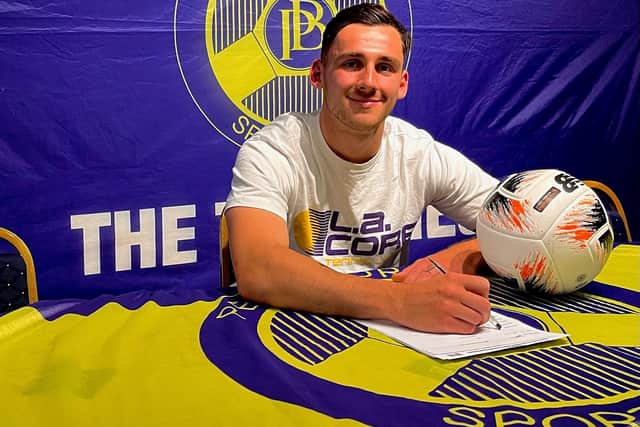Ben Fowkes signs on at Peterborough Sports. Photo Lillianna Armstrong.