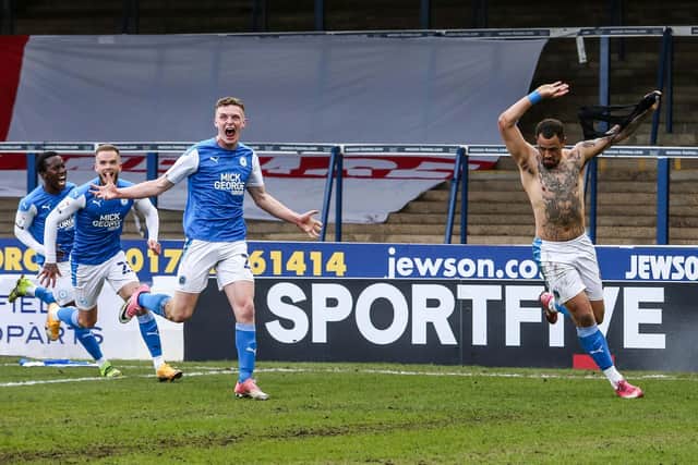 Jonson Clarke-Harris celebrates his promotion-winning goal for Posh against Lincoln in May, 2021. Photo: Joe Dent/theposh.com