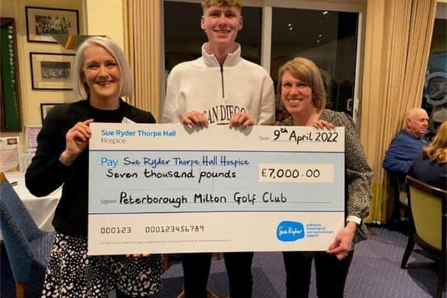 Kellie and Euan Herson present Sue Ryder Thorpe Hall Hospice with £7000 cheque from memorial golf day.
