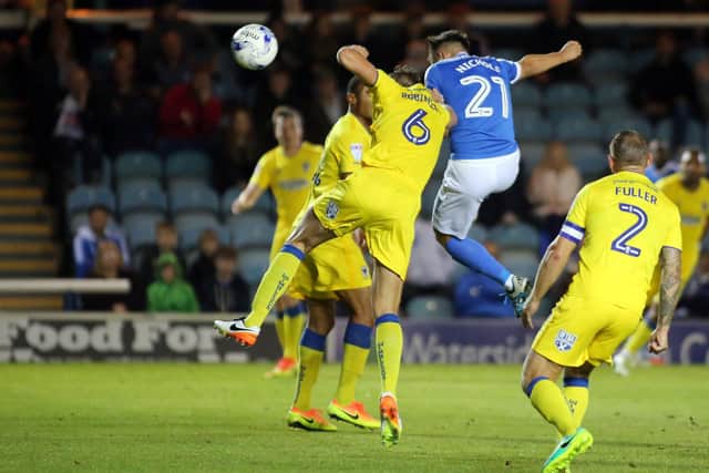 Tom Nichols (blue) scores for Posh against AFC Wimbledon in a 2016 League Cupe tie. Photo: Joe Dent/theposh.com