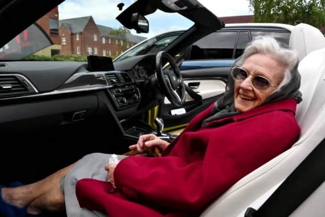 103-year-old Charlotte Hills, a resident of Hampton Grove care home, celebrates her birthday with a trip in a BMW convertible.