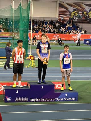 Lawson Capes on top of the medal podium after winning the National Indoor Under 15 shot out competition.