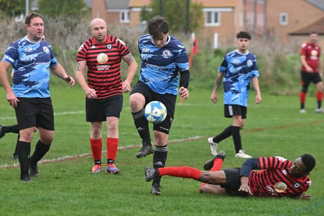 Action from Park Farm Pumas A 3, Elsea Park Eagles (blue) 4 in Division Three of the Peterborough League. Photo David Lowndes.