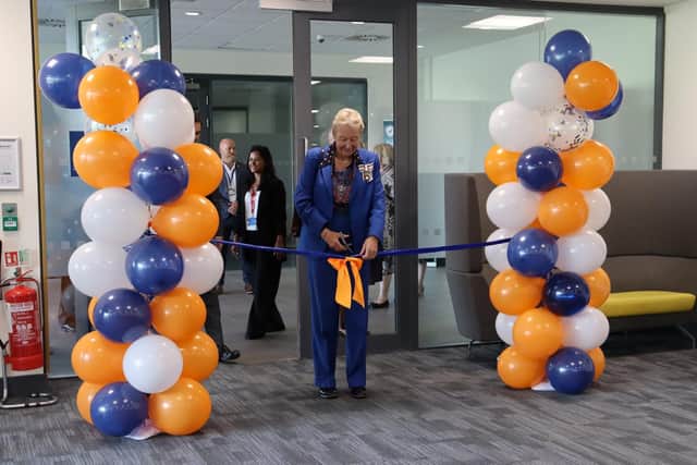 The Lord-Lieutenant of Cambridgeshire, Mrs Julie Spence OBE CStJ QPM, cuts a ribbon to mark the opening of HUC's new Peterborough contact centre.