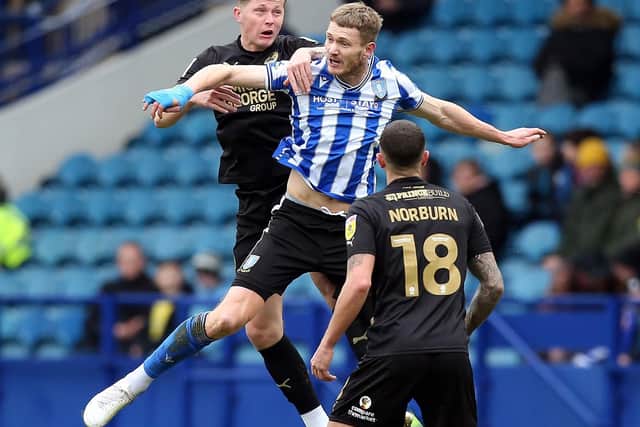 Frankie Kent of Peterborough United battles in the air with Michael Smith of Sheffield Wednesday. Photo: David Lowndes.
