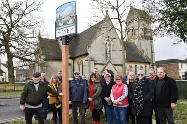 Villagers and parish councillors gather at the new sign.