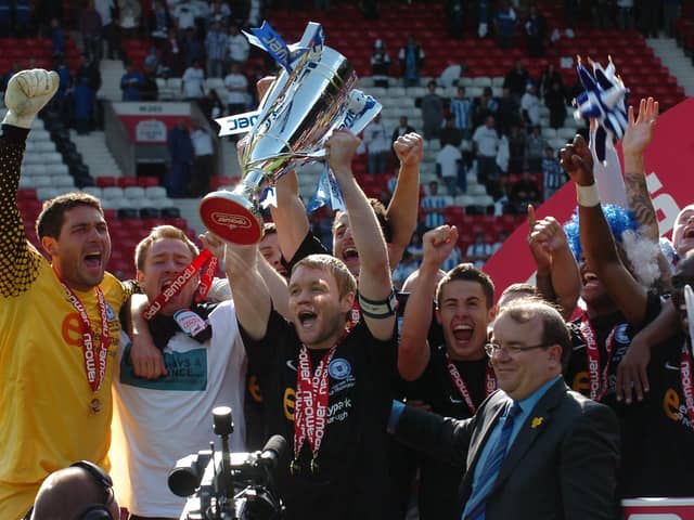 Posh skipper Grant McCann lifts the League One play-off winners trophy at Old Trafford in May, 2011. Photo: David Lowndes.
