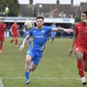 New Peterborough Sports signing Jordan Crawford (blue) in action during his goalscoring debut against Brackley. Photo: David Lowndes