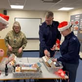 From Left: RAF Wittering Station Commander Wg Cdr Jez Case, OC 3MCS ; RAFA Wittering & District Branch Chair Sqn Ldr Sara Jones, Station Warrant Officer WO Darren
Rose and AS1 Annie Nicol putting the Christmas hampers together for local veterans.