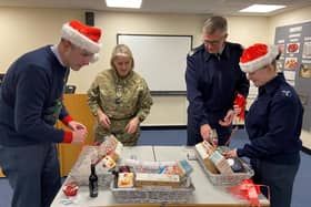 From Left: RAF Wittering Station Commander Wg Cdr Jez Case, OC 3MCS ; RAFA Wittering & District Branch Chair Sqn Ldr Sara Jones, Station Warrant Officer WO Darren
Rose and AS1 Annie Nicol putting the Christmas hampers together for local veterans.