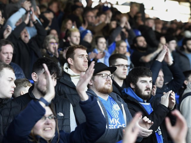 Peterborough United fans are pictured watching the crucial win over Derby County.
